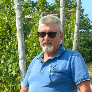 Beppe Scavino, Cascina delle Rocche winemaker, standing in vineyard