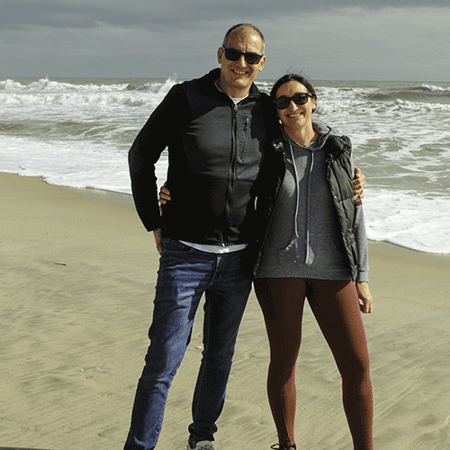 Photo of Marco and Cristina Doria standing on a beach