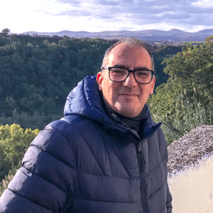 Photo of Marco Doria standing with mountains in the background